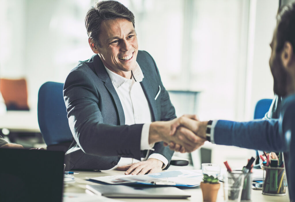 men shaking hands in an office