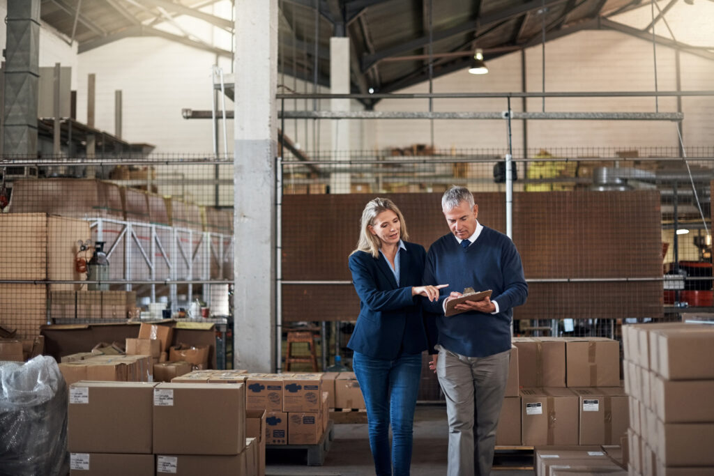 wo factory managers working together in a warehouse