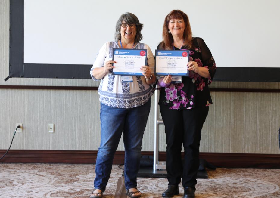 Two women Holding Certificates